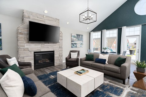 a living room with couches and a fireplace and a tv
