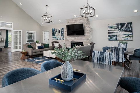 a living room with a dining table and a fireplace