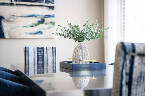a vase with flowers on a table in a living room