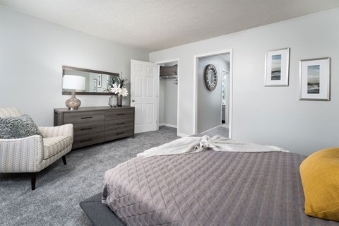 a bedroom with a bed and a dresser