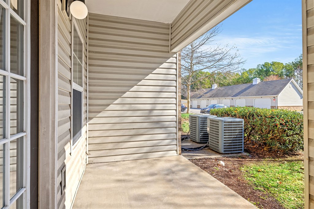 A sunny day at a residential house with a covered porch.