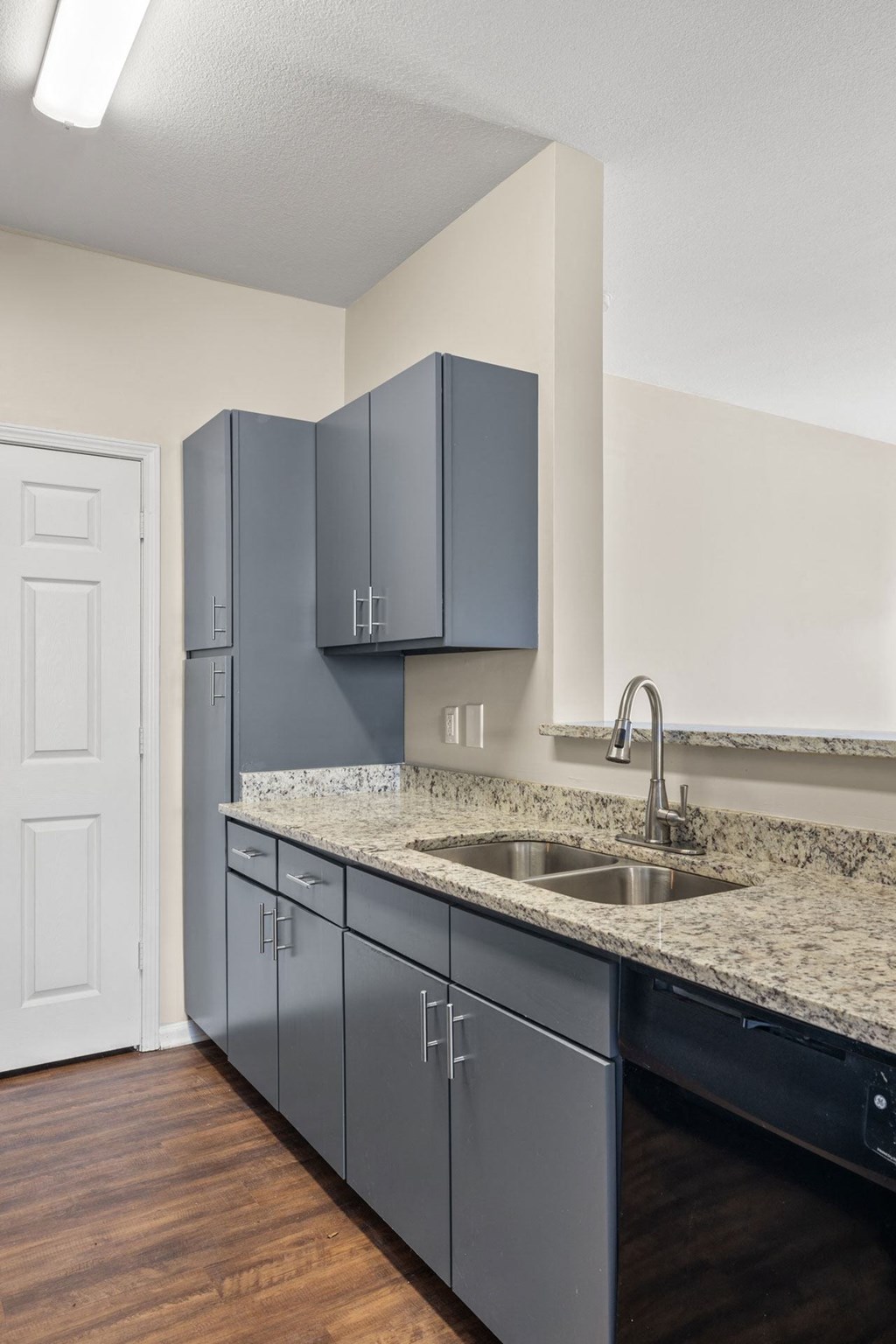 A kitchen with a sink and cabinets.
