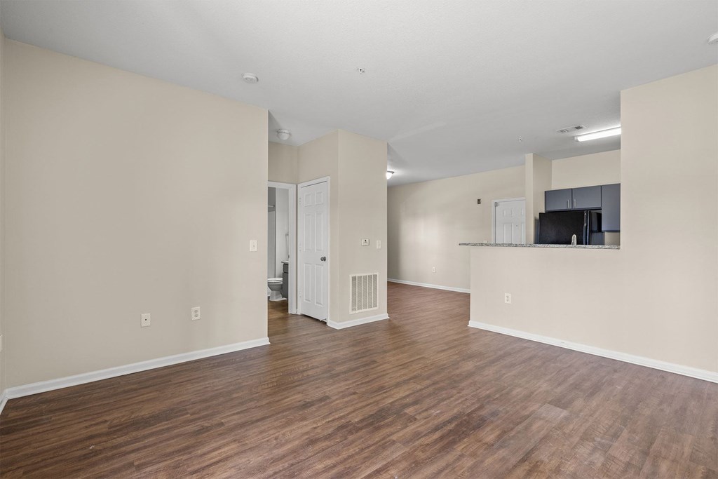 A room with wooden floors and white walls.