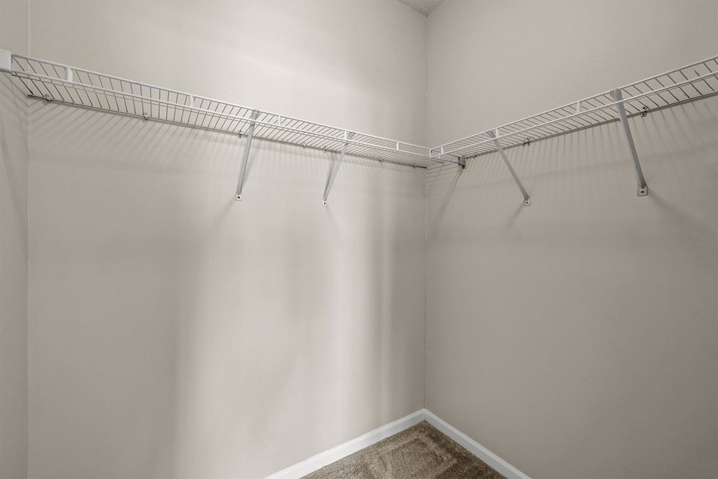 A white closet with a metal rack.