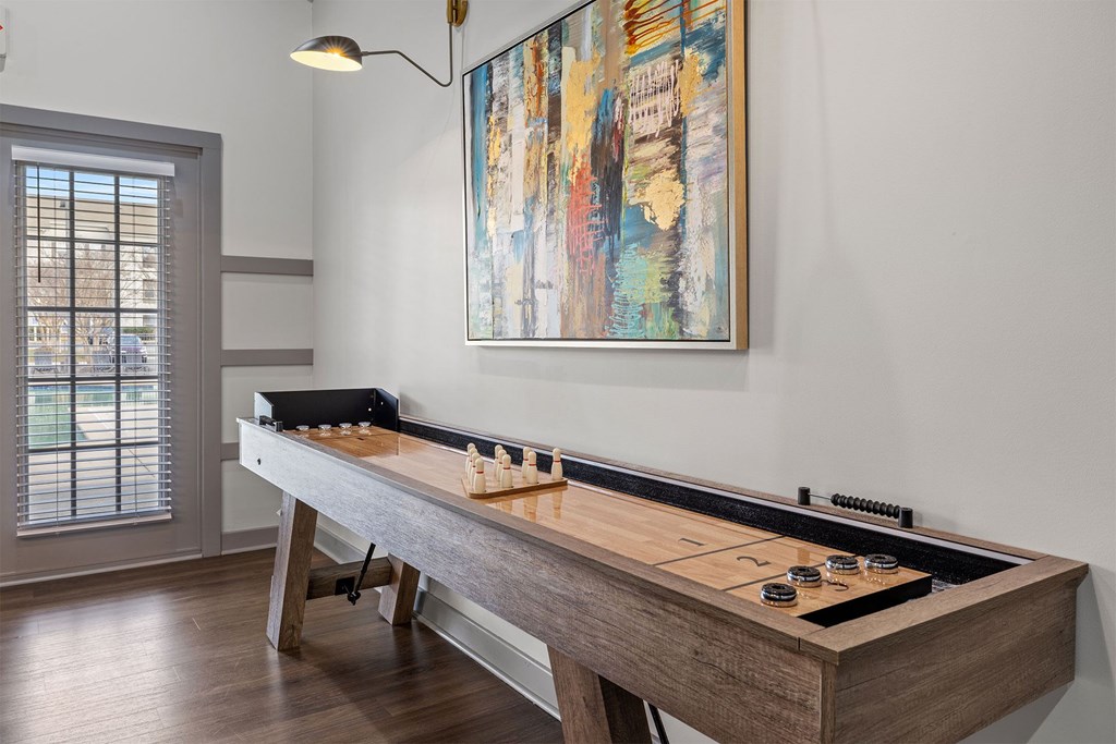 A shiny wooden table with a game set up on it.