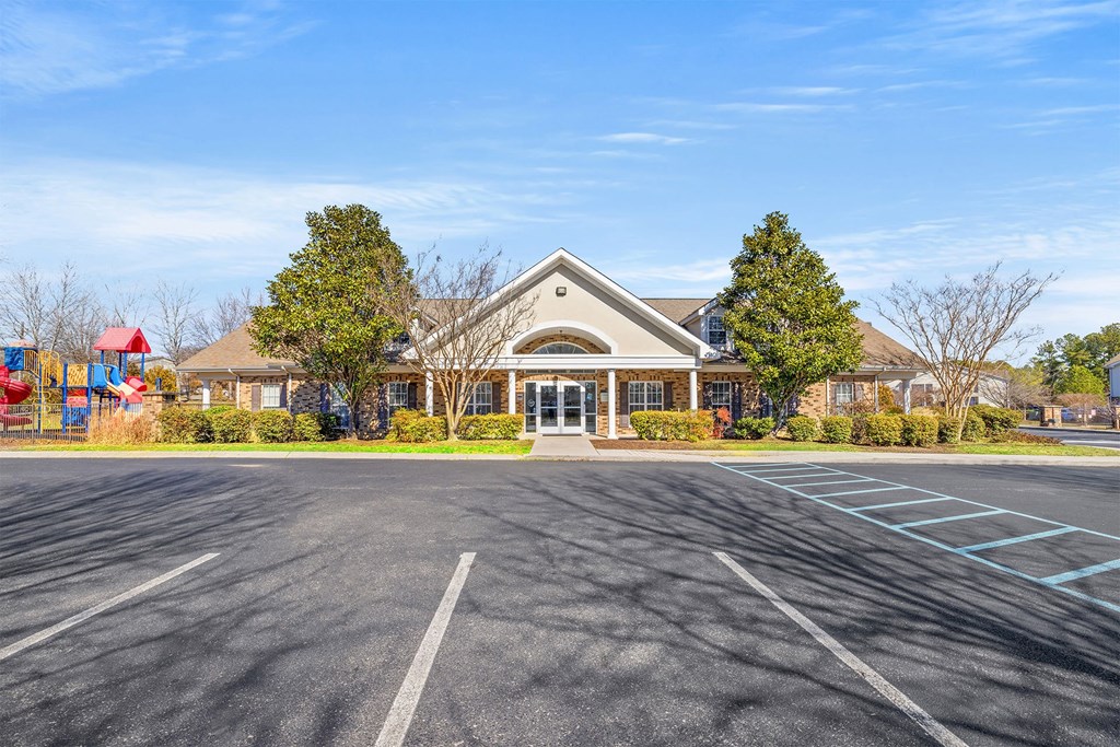 A large building with a parking lot in front of it.