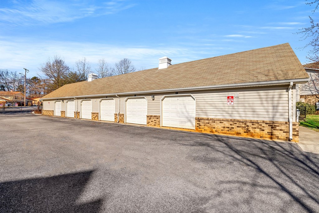 A building with a brown roof and a red sign on it.