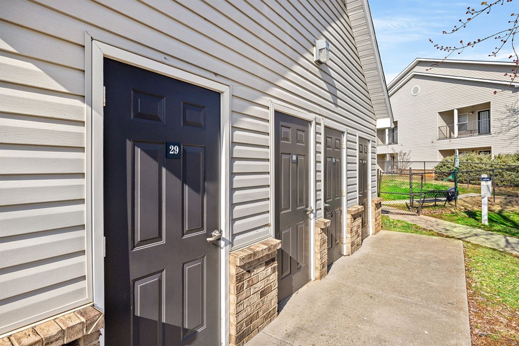 A row of houses with dark grey doors.