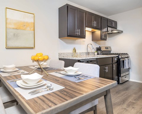 a kitchen and dining room with a table and chairs