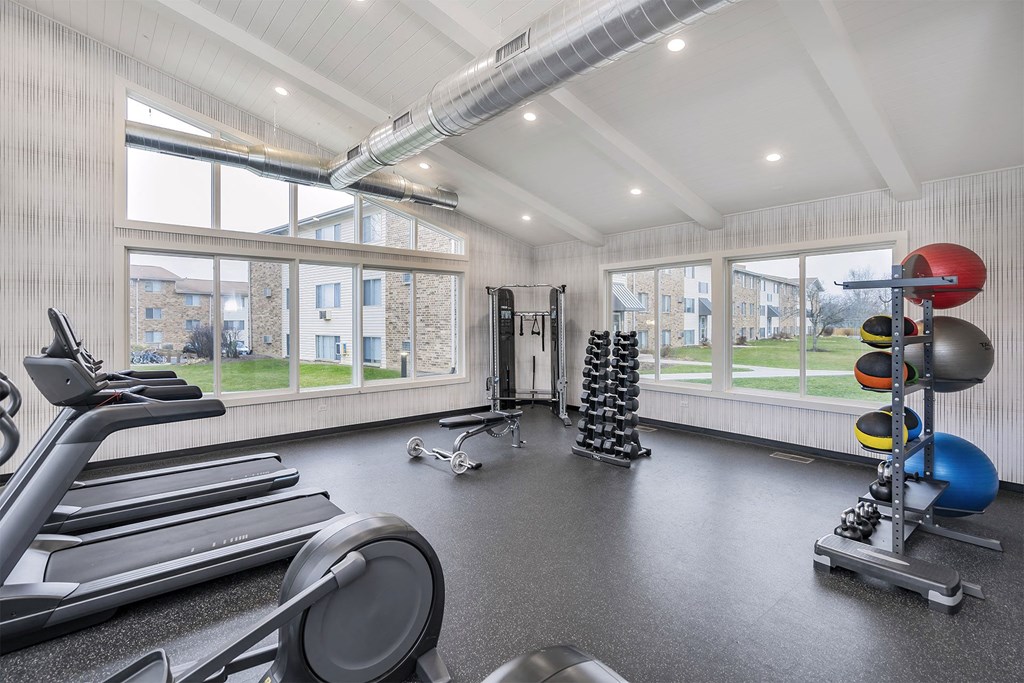 apartment fitness center with cardio and weight equipment