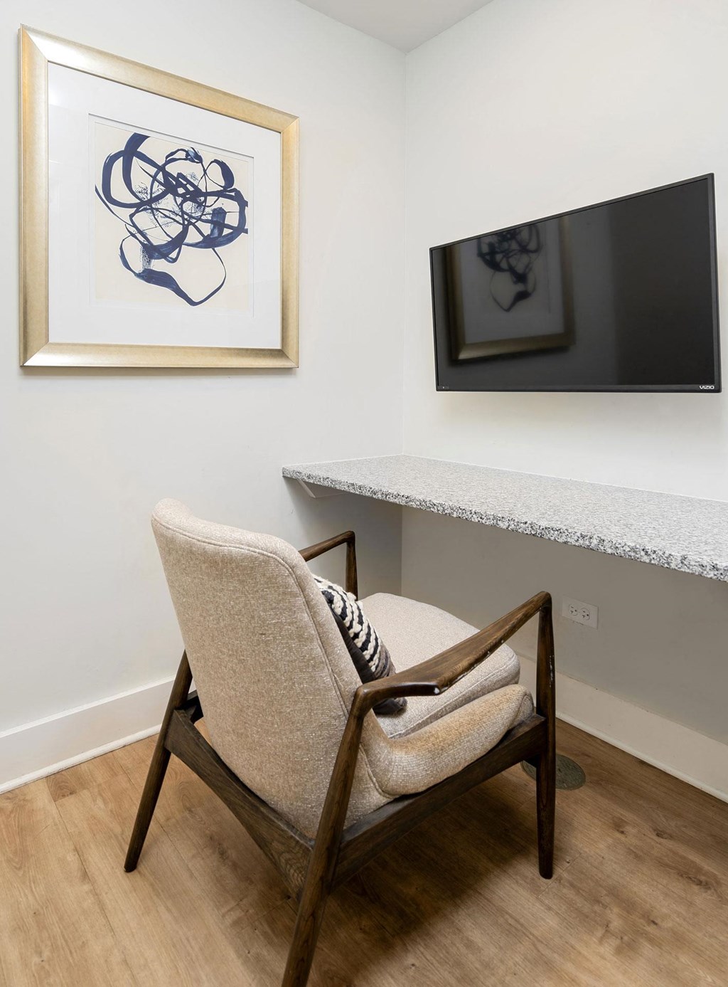 room with chair and wall-mounted tv