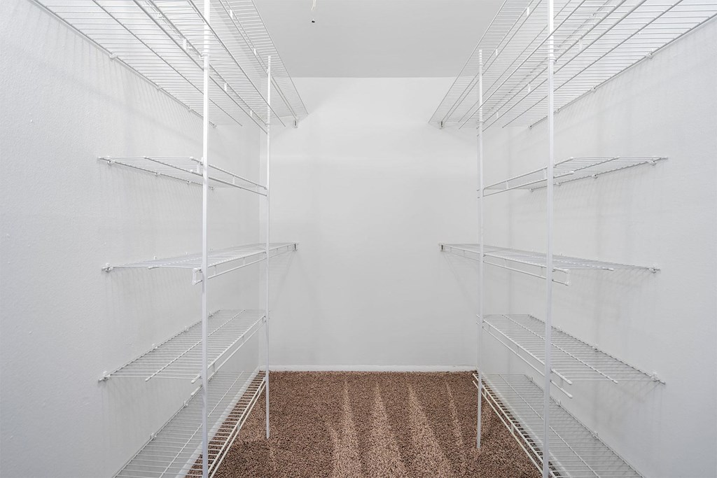 walk-in closet with white wire shelving