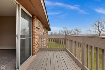 the deck of a home with a sliding glass door