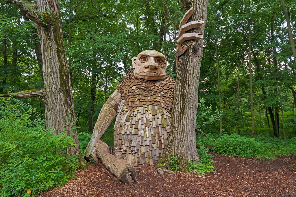 a statue of a man in the woods