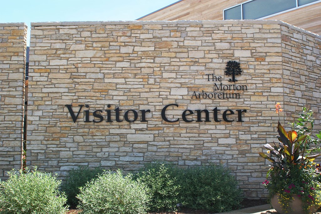 a brick building with a visitor center sign on it