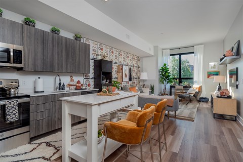 A modern kitchen with a dining table and chairs.