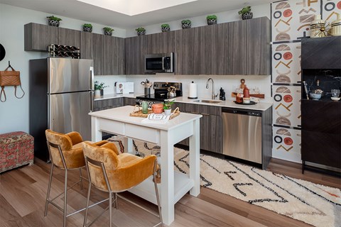 A kitchen with a white table and chairs.