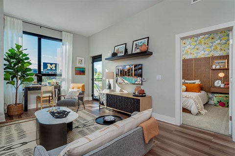 A living room with a grey couch and a coffee table.