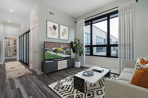 A living room with a grey couch and a coffee table.