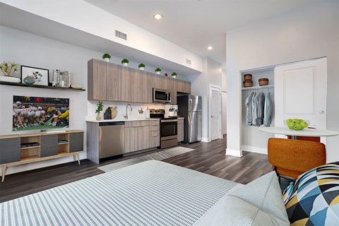 A modern kitchen with a dining table and chairs.