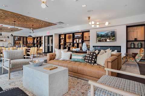 A living room with a variety of furniture including a sofa, armchairs, and a coffee table.