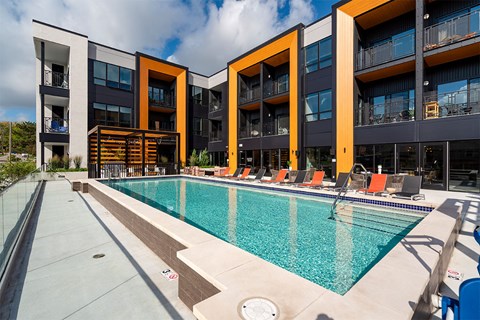 A swimming pool in front of a modern building.
