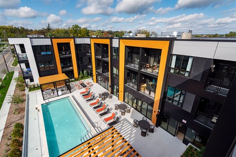 A modern building with a pool in front.