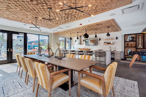 A dining room with a wooden table and chairs.