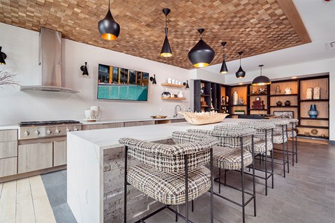 A kitchen with a checkered chair set.