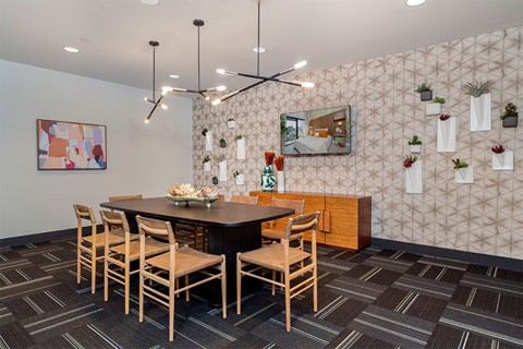 A dining room with a table and chairs.
