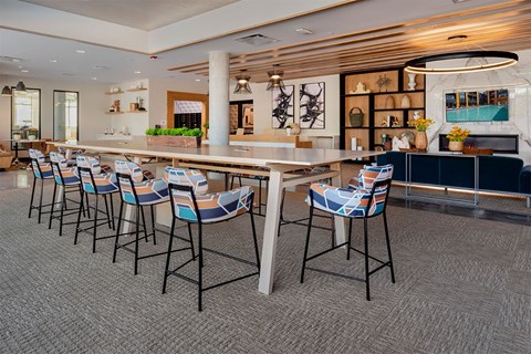 A long table with chairs is in the middle of a room.