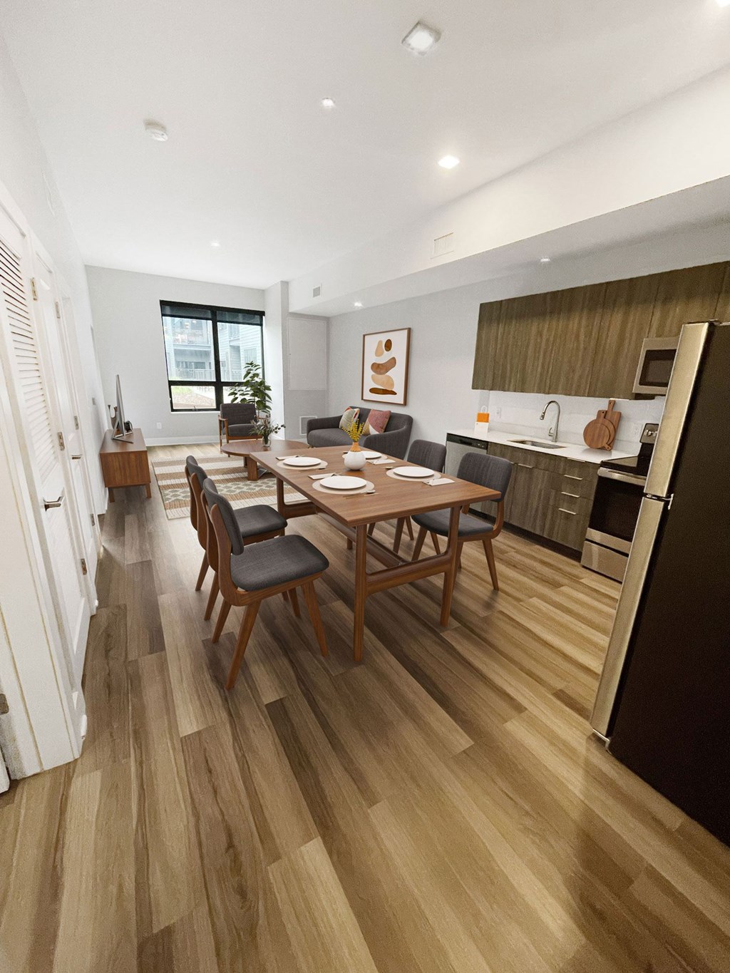 A modern kitchen with a dining table and chairs.