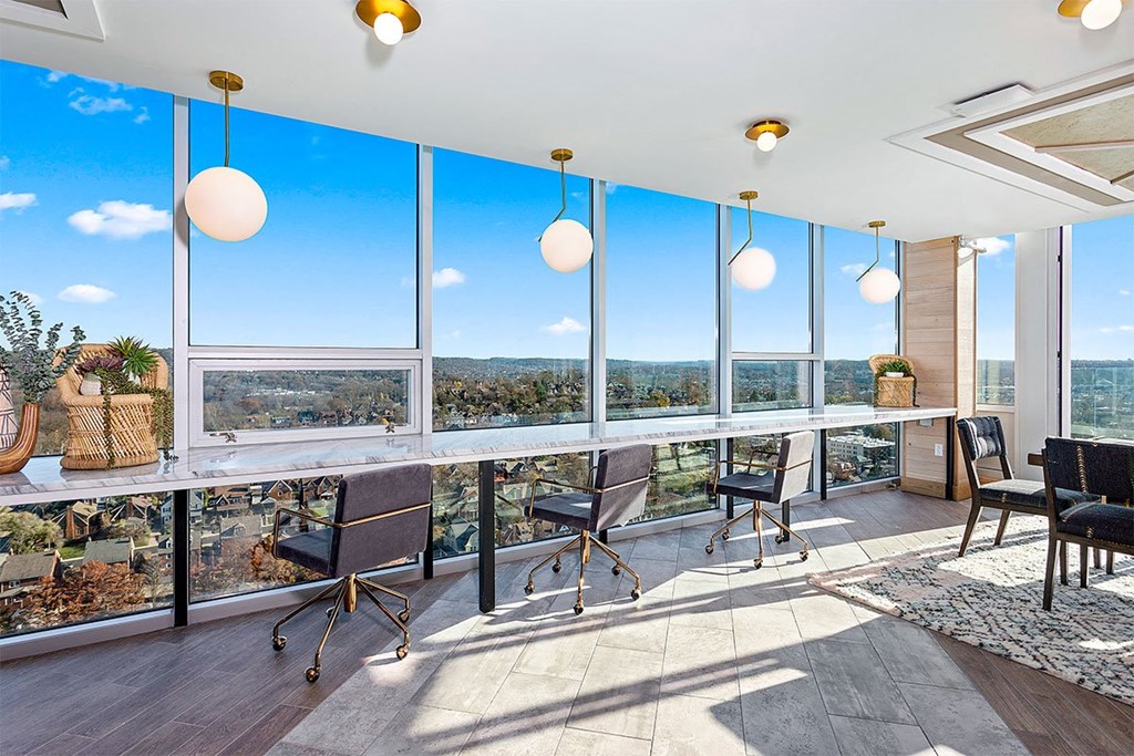 a view of the city from a room with a table and chairs
