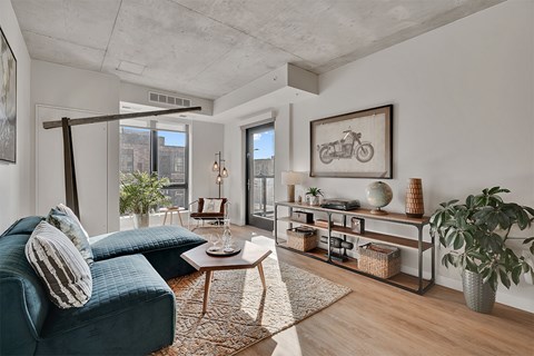 A living room with a blue sofa and a coffee table.