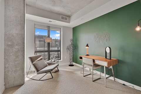 A room with a green wall and a chair.