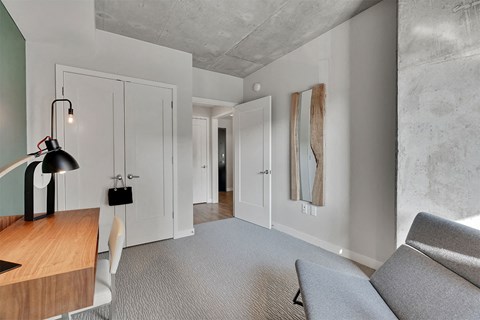 A modern living room with a grey sofa and a wooden table.