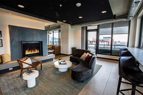 A modern living room with a fireplace and comfortable seating.
