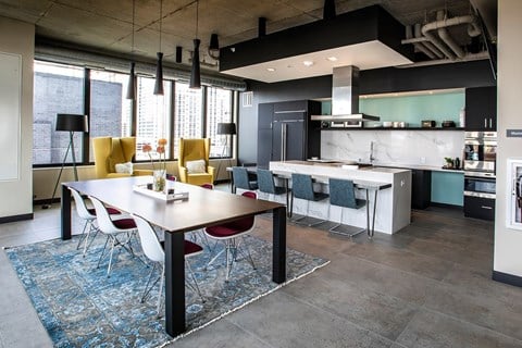 A modern kitchen with a dining table and chairs.