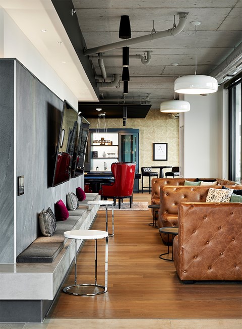 A modern living room with a long couch and a white table.
