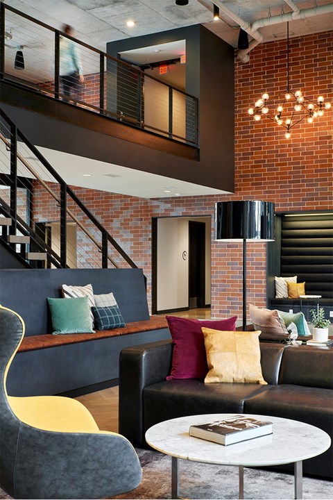 A living room with a grey couch and a yellow chair.