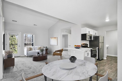 A modern kitchen with a dining table and chairs in the foreground.