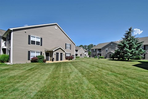 a row of houses with a yard in front of them