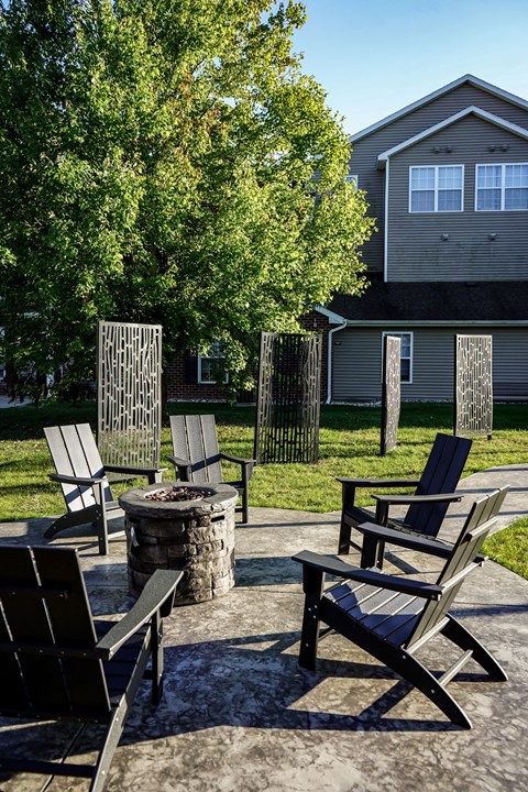 A set of chairs and a table are arranged on a patio.