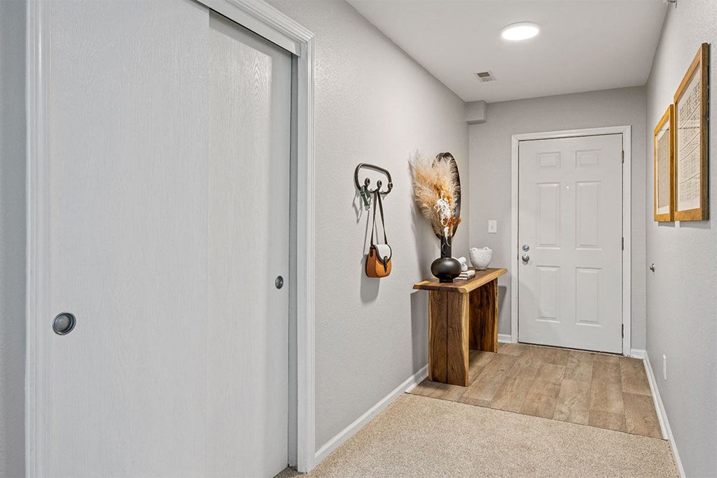 the entryway of a home with a white door