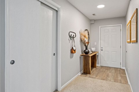 the entryway of a home with a white door