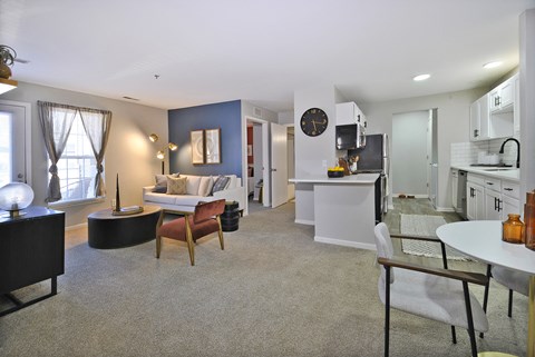 a living room with a kitchen and a dining room