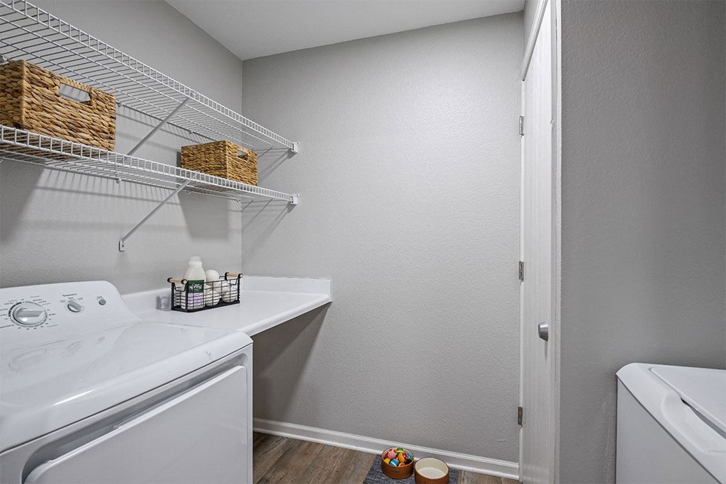 a laundry room with a washer and dryer and a sink