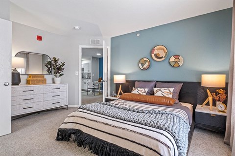 a bedroom with a bed and a blue wall