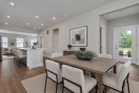 A modern dining room with a wooden table and chairs.