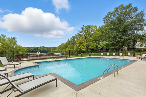 A large outdoor swimming pool surrounded by lounge chairs.